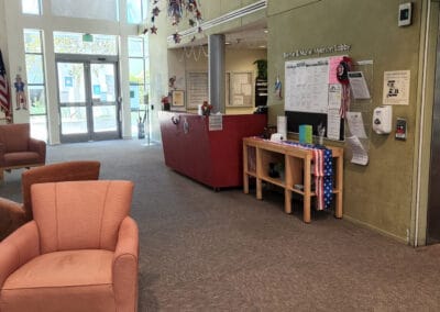 Lobby with seating and a desk next to an elevator