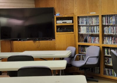 Tables and chairs in front of a TV