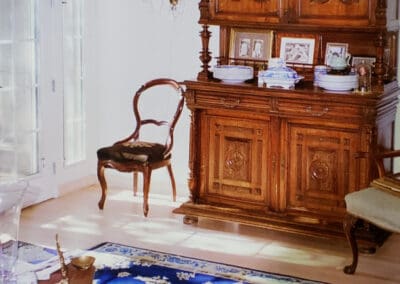 A wooden hutch in a room with a blue rug.