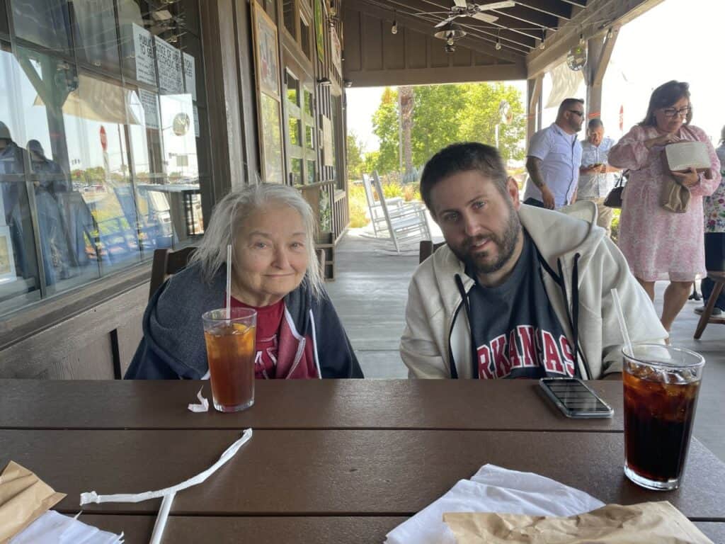 A man and woman sitting at a table with drinks.