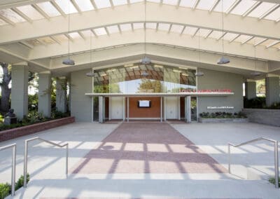 The entrance to a building with a glass roof.