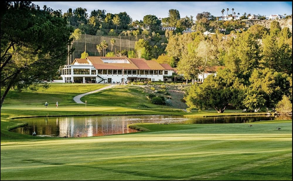A green golf course in a mountainous area.
