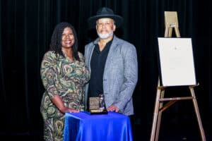 Filmmaker, actor, great grandnephew of Hattie McDaniel, Kevin Goff, on stage by the awarded plaque