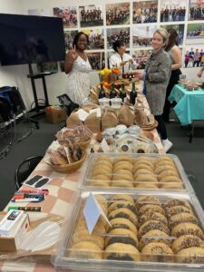 Office event with refreshments and two people smiling at the camera.