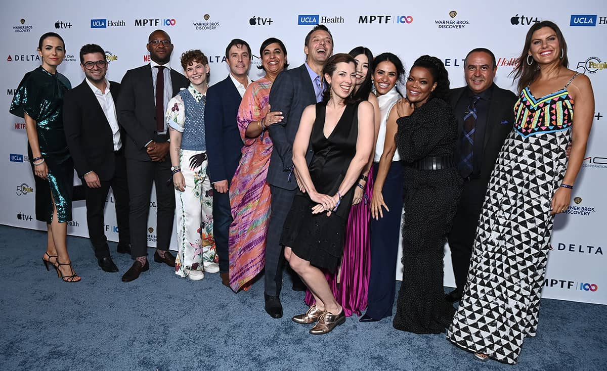 A group of people posing for a photo at an event.